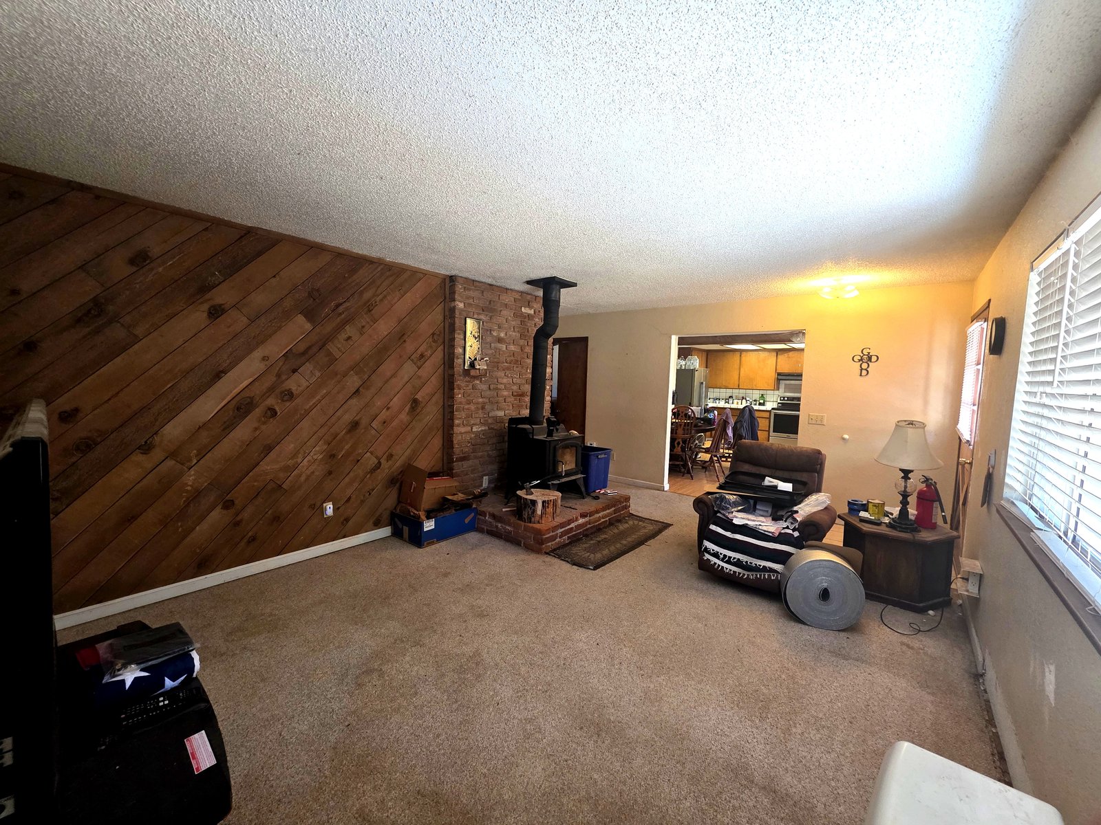 Living room with Kuma wood stove and brick hearth